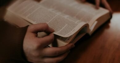 person holding white book page