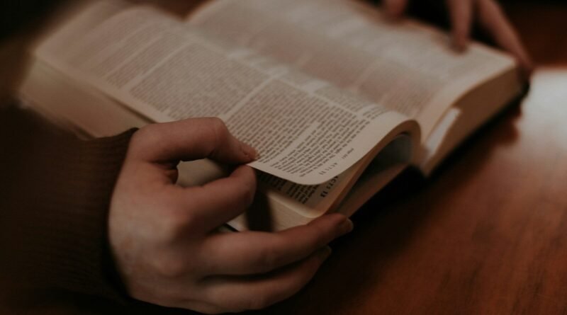 person holding white book page